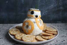 a star wars character made out of crackers is sitting on a plate with cookies