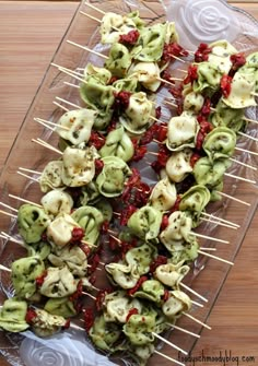 several skewers filled with food on top of a wooden table