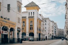 an empty city street with cars parked on both sides