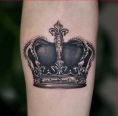 a black and white crown tattoo on the leg