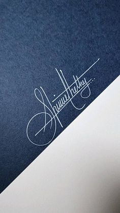 a close up of the logo on a blue and white paper with some type of writing