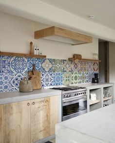 a kitchen with blue and white tiles on the backsplash