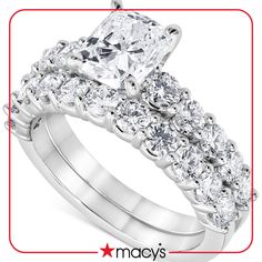 an engagement ring set with a princess cut diamond in the center and side stones on each band