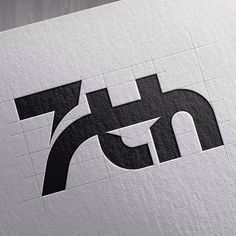 the letter t is made up of black and white letters on a piece of paper