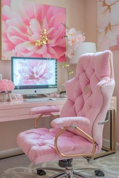 a pink chair sitting in front of a desk with a computer on top of it