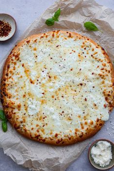 a pizza sitting on top of a table covered in cheese