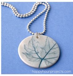 a necklace with a leaf etched on it