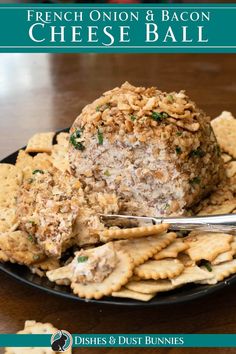 french onion and bacon cheese ball on a black plate with crackers next to it