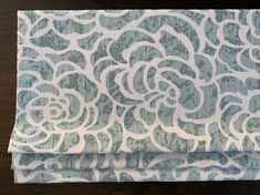 a blue and white flowered design on fabric