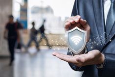 a man in a suit holding out his hand with a wifi shield on it