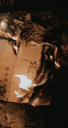 an open book sitting on top of a pile of rubble