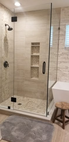 a bathroom with a walk in shower next to a sink