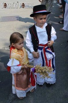 two young children dressed in costumes and hats