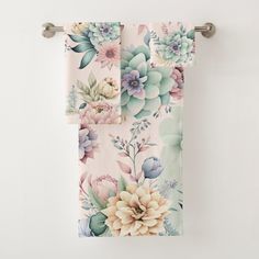 two towels hanging on a towel rack with succulents and flowers printed on them