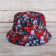 "Superhero Bucket Hat - Reversible Cotton Unisex One Size fits most. Soft flexible structure, easygoing aesthetic style made with a 100% Cotton fabric in a funky and colourful print allows the wearer to create their own individual fashion statement and show their Superhero pride for Spiderman! One size - fits 21.5\" - 23\" head. Will be a loose fit on a 21.5\", tighter fit on 23\" 3 1/2\" Height from 2.25\" Interfaced Brim 100% Printed Quilting Quality Cotton fabric & 100% Solid Black Cotton Canvas fabric on reverse. Send Message for Custom Sizing Requirements! Fabric Note: These are handmade items, so printed pattern placement on fabric may vary depending on how it is cut. The fabric used in this item has been pre-washed to avoid shrinkage. Care Instructions: The Bucket Hat can be washed Easygoing Aesthetic, Spiderman Hat, Cotton Hat, Aesthetic Style, Bucket Hats, Head Circumference, Black Canvas, Its My Birthday, Aesthetic Fashion