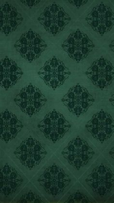 a green wallpaper with an ornate design