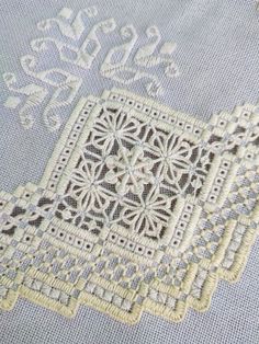 an embroidered piece of cloth with lace on it