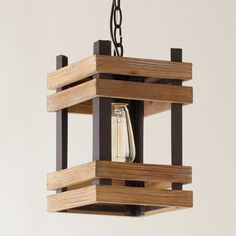 a wooden light fixture hanging from a ceiling