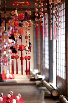 a room filled with lots of decorations hanging from it's ceiling next to windows