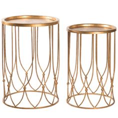 two gold metal side tables with glass tops and wire work on the sides, one is turned upside down