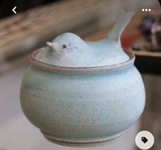 a blue ceramic bowl sitting on top of a table