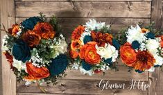 three bouquets of orange, white and blue flowers are arranged on a wooden background