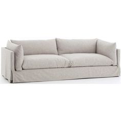 a white couch with two pillows on it's back and one arm folded up