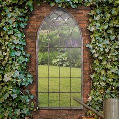 an arched window is surrounded by ivy