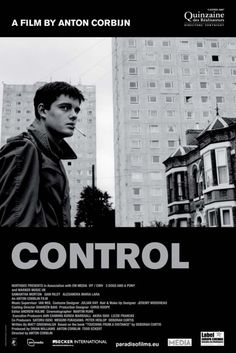 a man standing in front of tall buildings with the words control written across his face