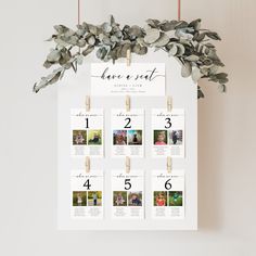 a wedding seating chart hanging on a white wall with eucalyptus leaves and wooden pegs