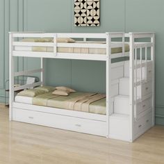 a white bunk bed with drawers underneath it