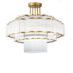 a chandelier hanging from the ceiling with glass rods and gold trimmings