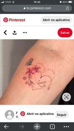 a small tattoo on the arm of a girl with flowers and a heart in it