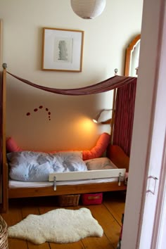 a bedroom with a bed that is made out of wood and has a white rug on the floor