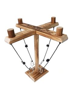 a wooden structure with ropes attached to the sides and two candles on each side, in front of a white background