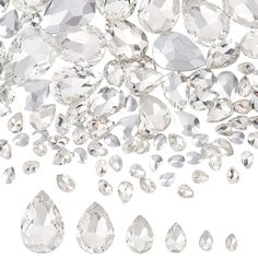 many diamonds are falling down on the white surface, with one being surrounded by smaller ones