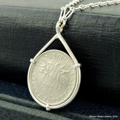 This is a custom order item. Your order will ship within 3-5 business days of payment confirmation. The coin pendant in the listing photos is an example of the finished piece. Excluding the year on the coin, your coin pendant will be the same design as the pictured pendant. Each pendant setting is made by hand (not a machine), and no two coins are exactly alike. If you are looking for a specific year, let me know, I may have it in my collection. This France 1 Franc Coin rests in a handcrafted se Silver Coin Jewelry, French Coins, Custom Coins, Silver Coin Necklace, Metal Smithing, Portfolio Ideas, Diy Fashion Hacks, Round Necklace, Craft Stuff