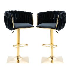 pair of black velvet bar stools with gold metal base and foot rests on white background