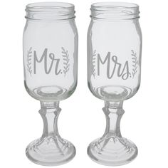 two clear glass wine glasses with the word mr and mrs written on each one side