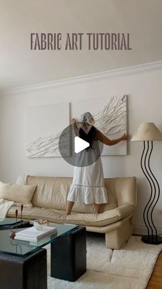 a woman standing in front of a white couch