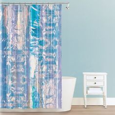 a shower curtain with blue and white designs on it in a bathroom next to a tub