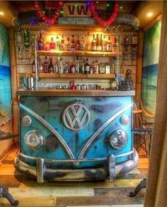 an old vw bus bar is painted blue and has lights on the ceiling above it