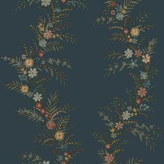 a blue wallpaper with flowers and leaves on the bottom half of it, against a dark background