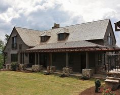 a large house sitting on top of a lush green field