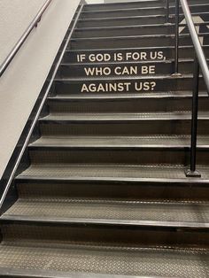 an escalator with a sign on it saying if god is for us, who can be against us?