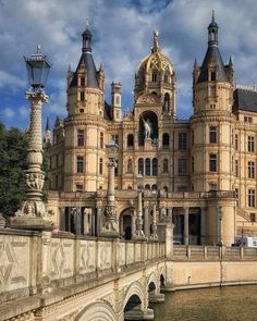 a large building with many windows on the side of it and a bridge in front of it