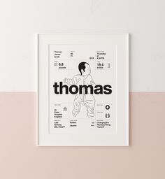 a white framed poster with the words thomas on it