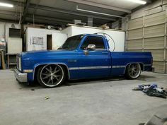 a blue truck is parked in a garage