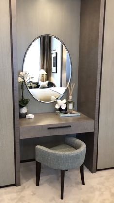 a dressing table with a mirror and stool