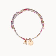 The A-Z of you and me. Build your own alphabet with our Personalized Mini Alphabet Liberty Bracelet by hand-engraving a treasured name or date onto the smooth pastille charm and adding up to 3 delicate letter charms to represent loved ones and little ones. Create a colourful gift by choosing a floral Liberty print to match a special personality18K Champagne Gold Plated and 925 Sterling SilverMini flat disc: 0.4 Diameter, 0.02 ThicknessMini alphabet charm: 0.2Liberty braid with fully adjustable s Liberty Bracelet, Alphabet Charms, Alphabet Charm, Colorful Gifts, Sliding Knot, Liberty Print, Letter Charms, Champagne Gold, Hand Engraving